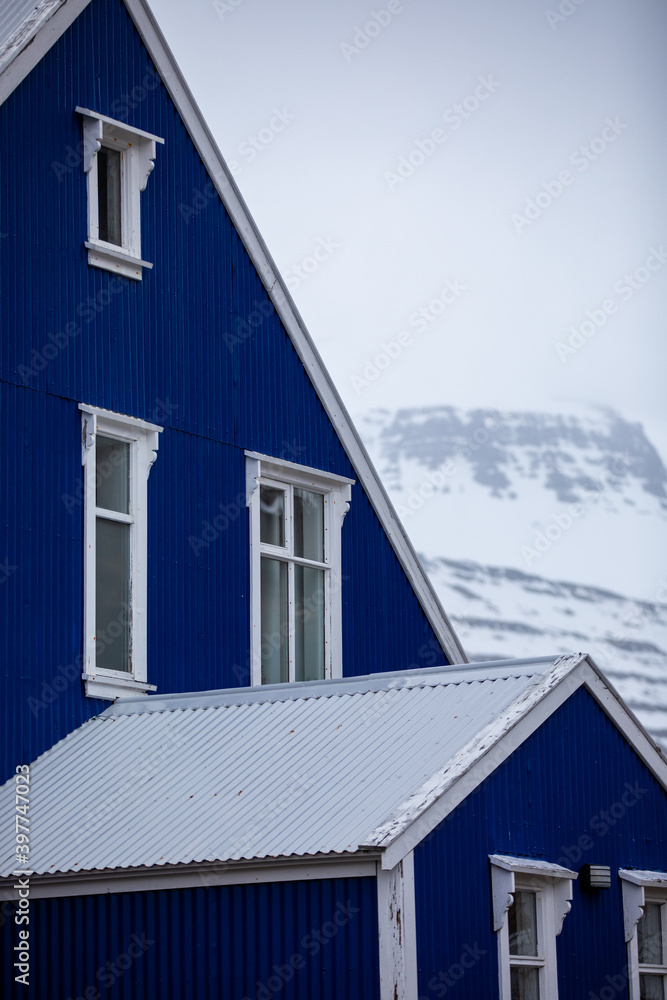 A traditional blue Scandinavian house in the mountains in Iceland