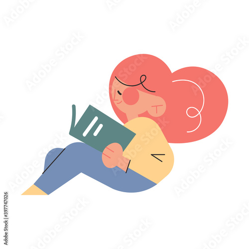 Happy small girl sitting on floor and reading book