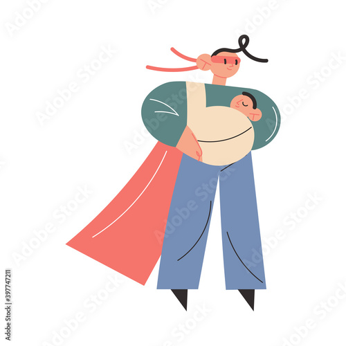 Happy young father in superhero costume carrying small baby in sling