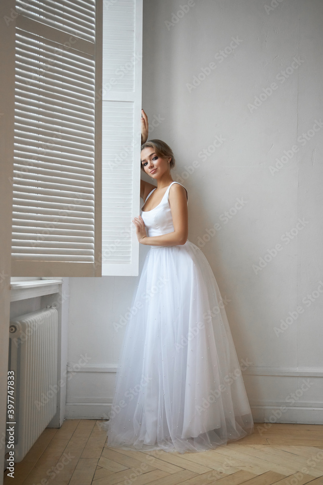 Beautiful slender woman in white wedding dress, new collection of dresses for the bride. Noise, out of focus Beautiful slender woman in white wedding dress, new collection of dresses for the bride. Noise, out of focus