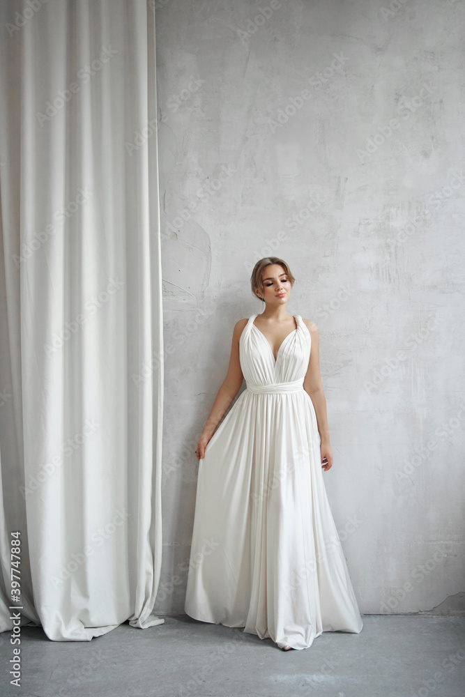 Beautiful slender woman in white wedding dress, new collection of dresses for the bride. Noise, out of focus Beautiful slender woman in white wedding dress, new collection of dresses for the bride. Noise, out of focus