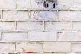 Old Vintage white Brick wall with a Sprinkle of white stucco background texture. abstraction
