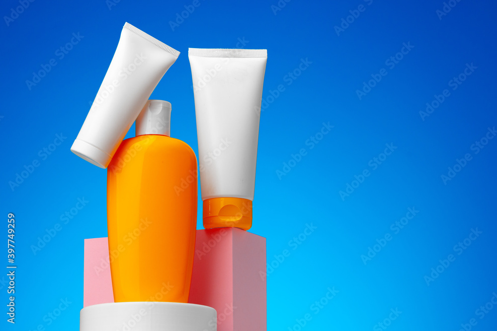 Skincare beauty products container against blue background Skincare beauty products container against blue background