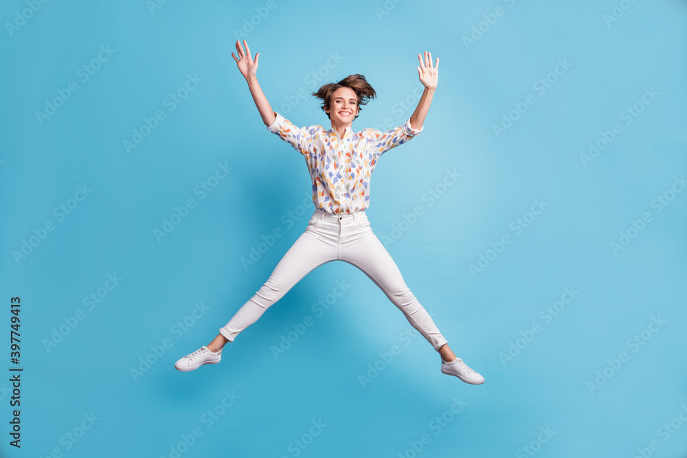 Full length photo of young attractive girl have fun enjoy jump up crazy isolated over blue color background Full length photo of young attractive girl have fun enjoy jump up crazy isolated over blue color background