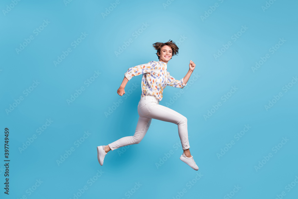 Full size profile side photo of young girl happy positive smile jump run hurry sale isolated over blue color background