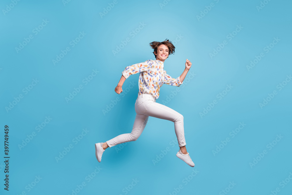 Fototapeta premium Full size profile side photo of young girl happy positive smile jump run hurry sale isolated over blue color background