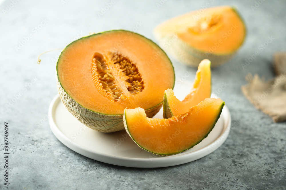 Fresh honey melon on a white plate Fresh honey melon on a white plate