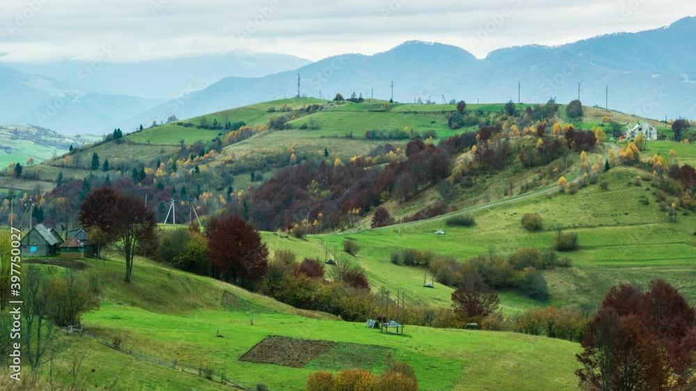 Sky with white and fluffy layer of clouds over green autumn hills, 4K UHD time lapse
