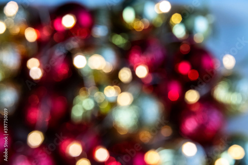 Gold and red bokeh abstract background with defocused lights and Christmas balls.