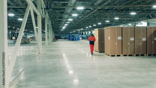 Factory facility intside. Refrigeration factory storage unit with a male employee photo