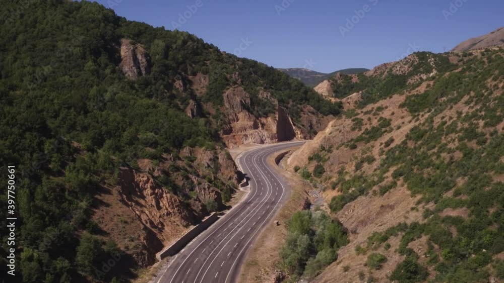 Empty wide autobahn. Turkish winding highway through rocky mountains at summer sunny day. Aerial drone view. Empty wide autobahn. Turkish winding highway through rocky mountains at summer sunny day. Aerial drone view.