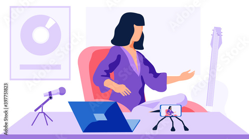 Female character in a purple sweater sits at the table, shoots video and reads the message on a microphone. Woman recording the text and shoots it against the background of a music award and a guitar