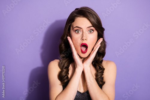 Portrait of attractive amazed worried wavy-haired girl opened mouth isolated bright violet color background