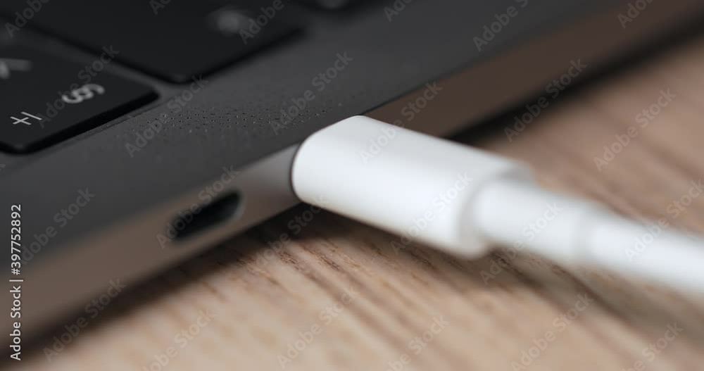 Close up of the charging wire inserted into the connector Close up of the charging wire inserted into the connector