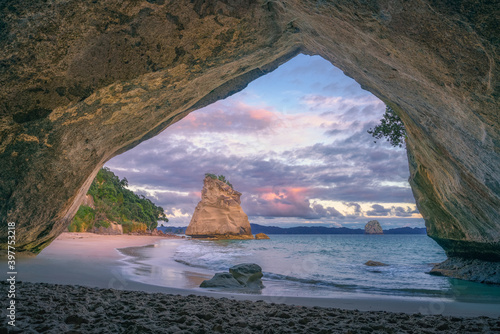 view from the cave at cathedral cove beach at sunrise,coromandel,new zealand