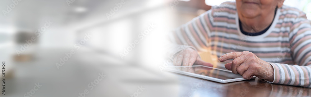 Elderly woman and new technologies; panoramic banner Elderly woman and new technologies; panoramic banner