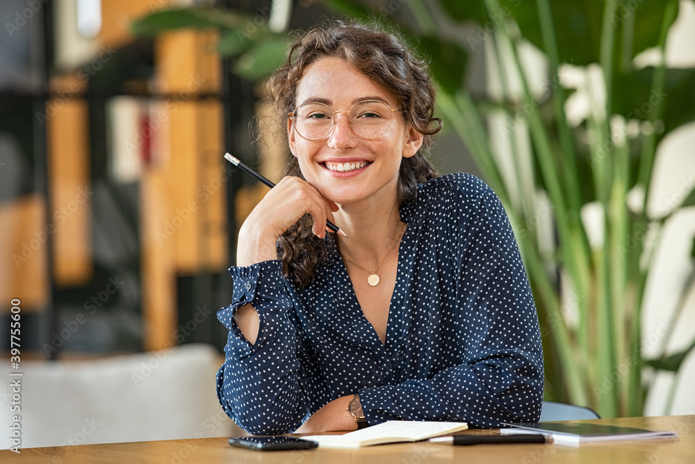 © Rido - Portrait of happy smiling woman at desk © Rido - Portrait of happy smiling woman at desk