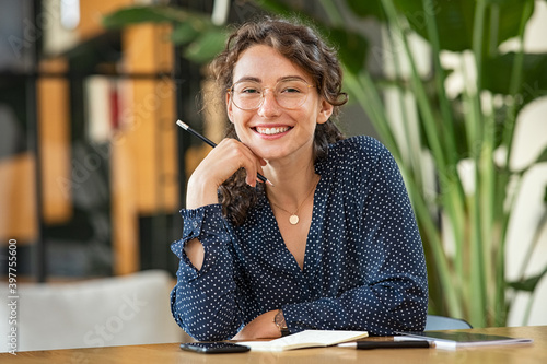 Portrait of happy smiling woman at desk photo