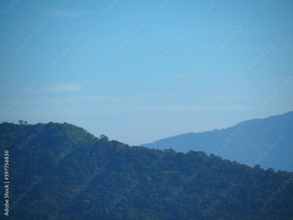 Silhouette Landscape view, Part of mountain and blue sky with plenty dust in the air. Dust pollution concept. 