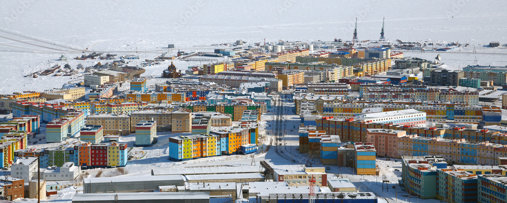 Winter panorama of the city of Anadyr. Aerial view of a town located in the far North of Russia in the Arctic. Anadyr is the easternmost city in Russia. Street and colorful buildings. Anadyr, Chukotka