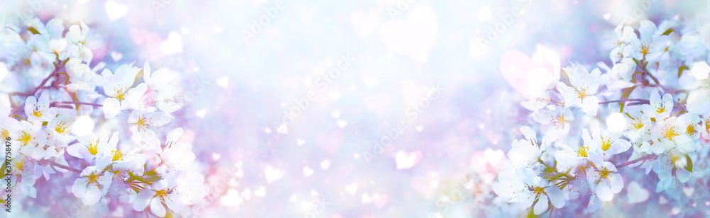 Valentine's Day. Beautiful spring flowers blurred background with heart bokeh effect