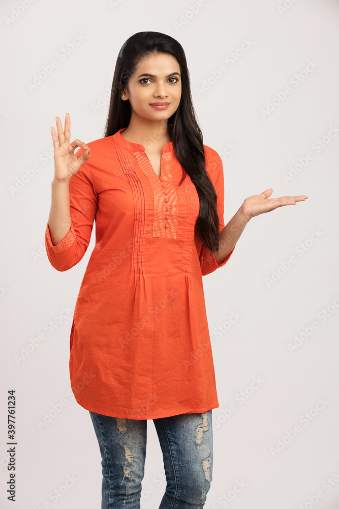 Pretty Indian young woman greeting on white. Pretty Indian young woman greeting on white.