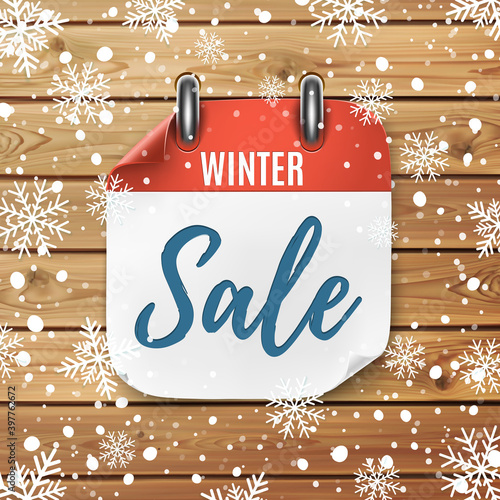 Winter sale. Realistic calendar icon. Wooden background with snow and snowflakes.