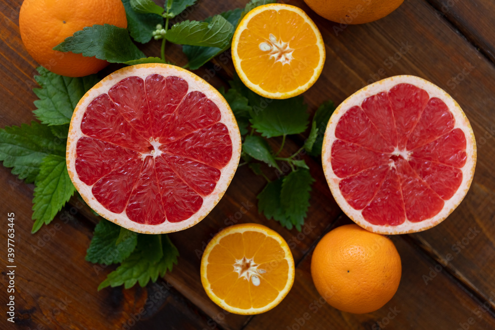 oranges and grapefruit on a brown wooden background, top view, text space, citrus oranges and grapefruit on a brown wooden background, top view, text space, citrus