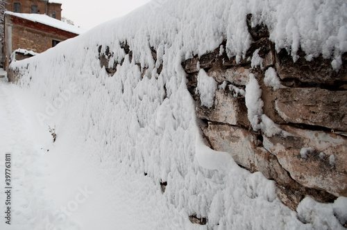 stone wall with snow, snow on the fence