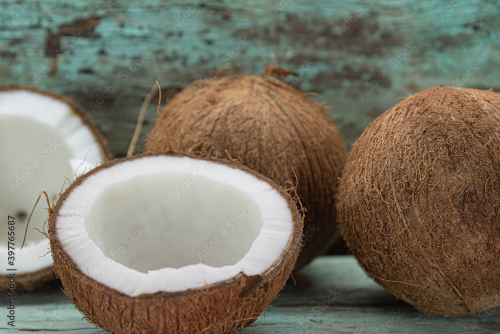 Dried coconut fruits in natura on aged wooden background Dried coconut fruits in natura on aged wooden background