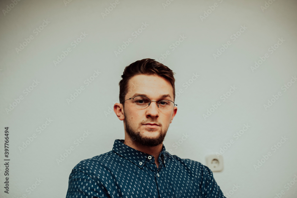 Obraz premium a portrait of a successful caucasian businessman wearing glasses and a blue shirt
