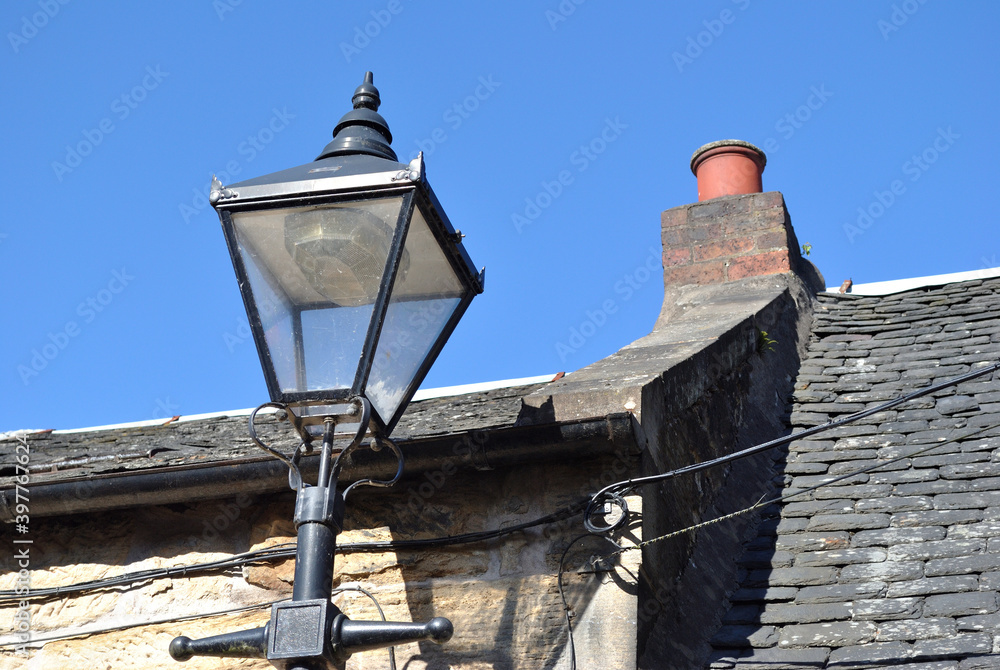 Traditional Metal Street Light with Lantern  seeen from Below against Blue Sky 