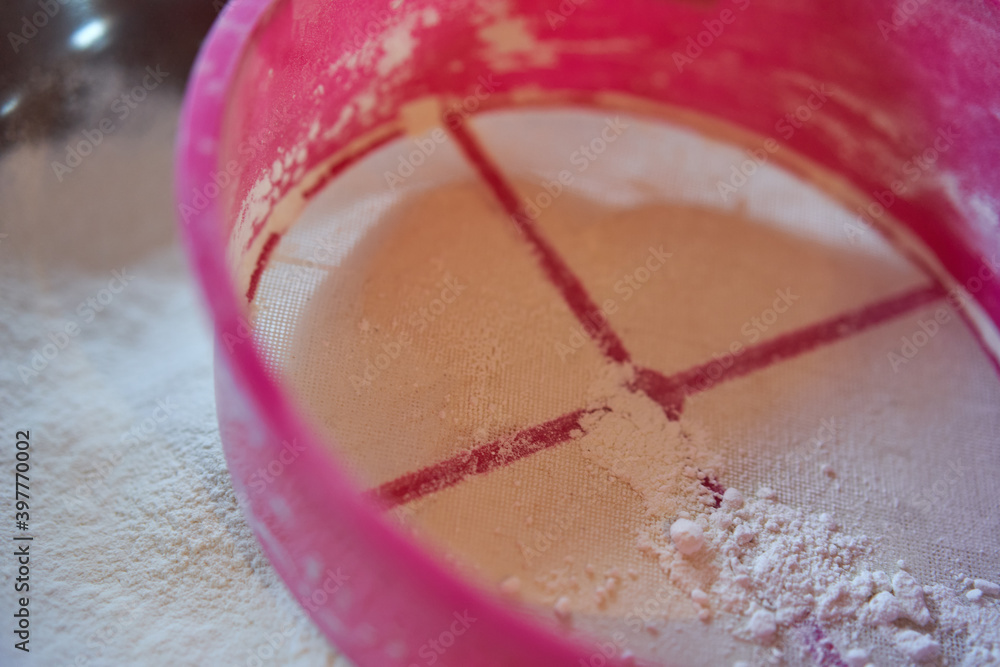 Sifting flour with sieve Sifting flour with sieve