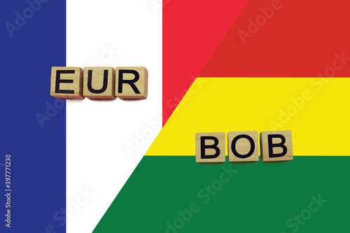 France and Bolivia currencies codes on national flags background © andreyakaan147