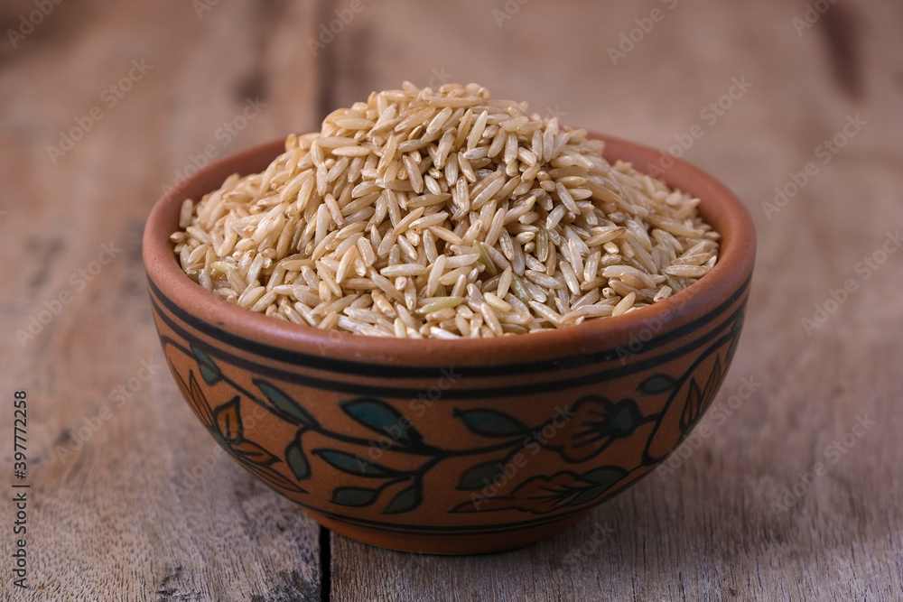 Raw brown rice in a bowl Raw brown rice in a bowl