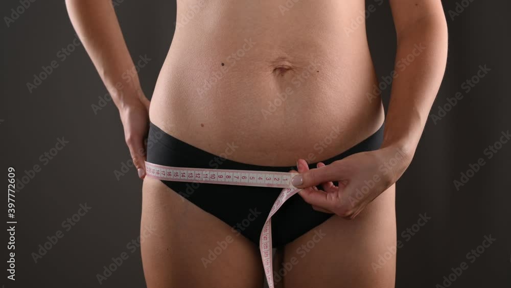 The girl makes a measurement of the waist. High quality video The girl makes a measurement of the waist. High quality video
