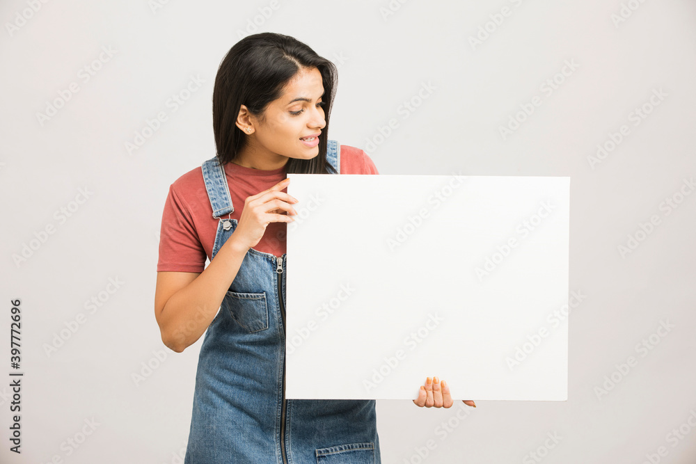 Cheerful attractive young women holding white board on white. Cheerful attractive young women holding white board on white.
