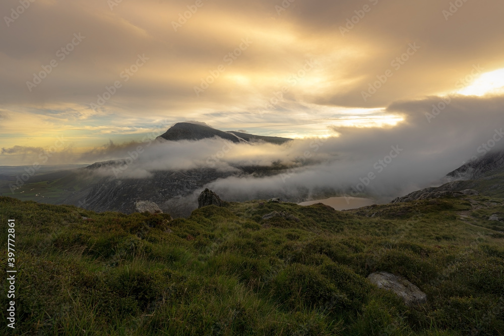 A dramatic sunrise scene in the mountains of Snowdonia National Park in Wales UK