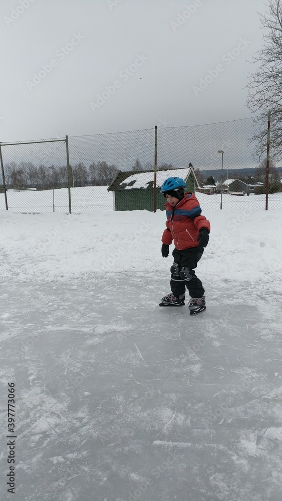 A little boy ice-skating in winter with various poses.