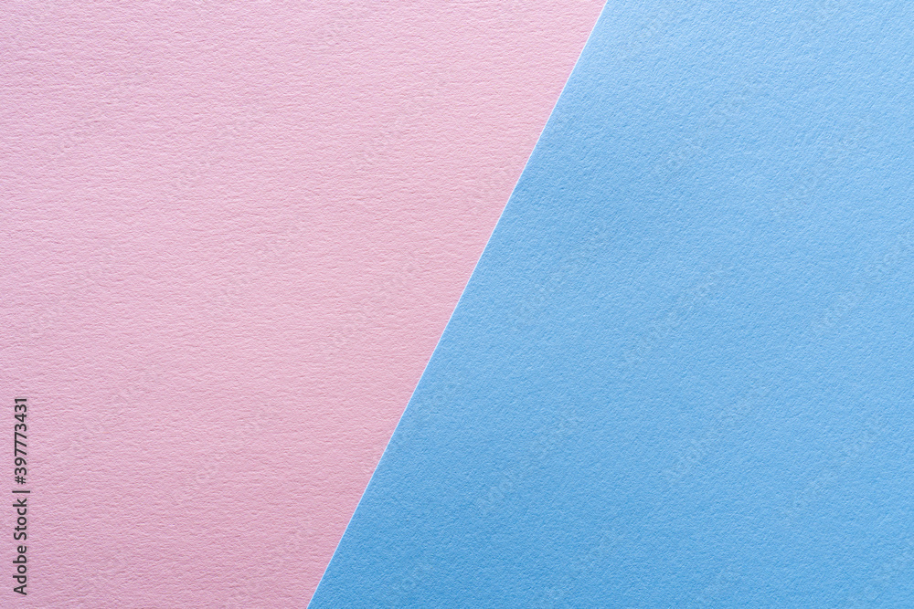 Beautiful background of two parts of colored paper pastel blue and pink. Sheets of blank light blue and pink paper with fine texture devided by a sloping border. Beautiful background of two parts of colored paper pastel blue and pink. Sheets of blank light blue and pink paper with fine texture devided by a sloping border.