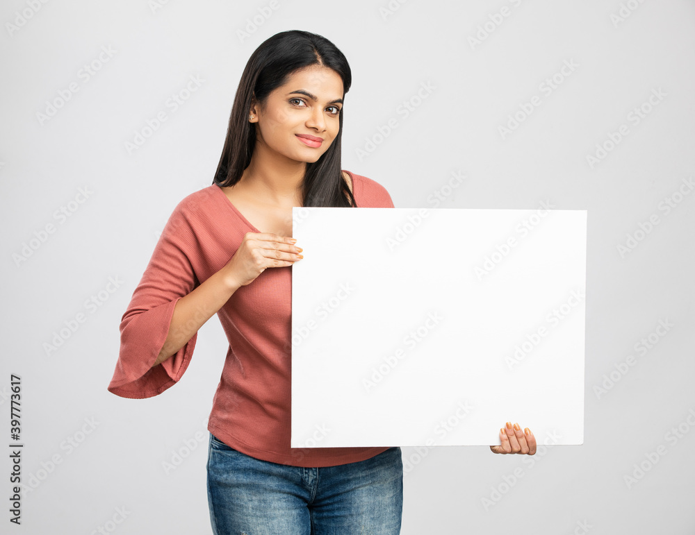 Cheerful Indian young woman enjoying music on white. Cheerful Indian young woman enjoying music on white.