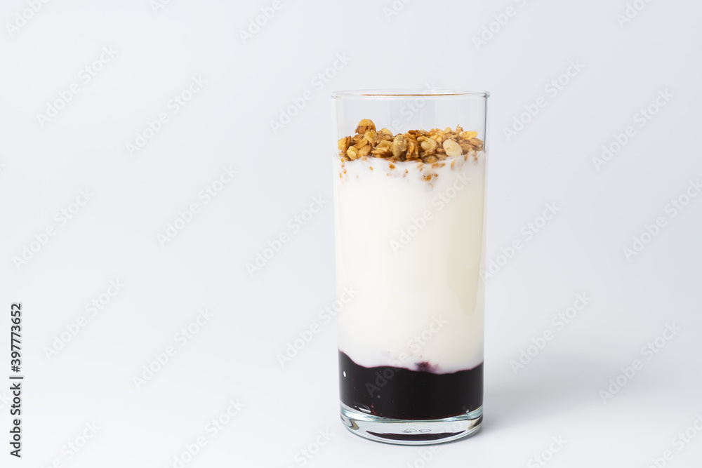 Healthy layered dessert with bio yogurt, granola and balckcurrant jam on white background. Healthy layered dessert with bio yogurt, granola and balckcurrant jam on white background.