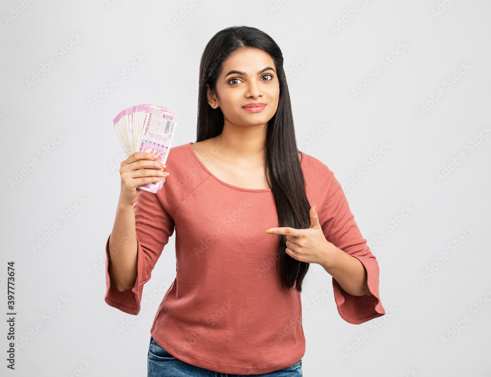 Young woman holding rupee notes-Money savings concept Young woman holding rupee notes-Money savings concept