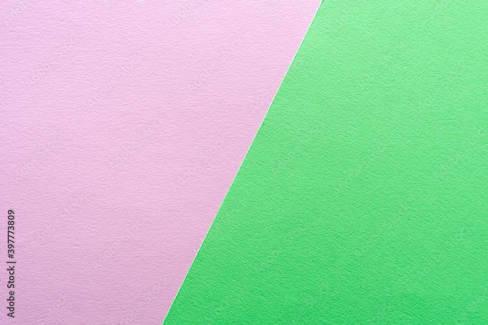 Paper texture background of pastel green and pink colors. Sheets of blank light green and pink paper with fine texture devided by a sloping border. Paper texture background of pastel green and pink colors. Sheets of blank light green and pink paper with fine texture devided by a sloping border.