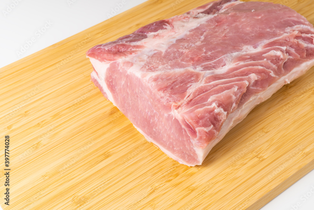 Piece of raw boneless pork loin on cutting board. Piece of raw boneless pork loin on cutting board.