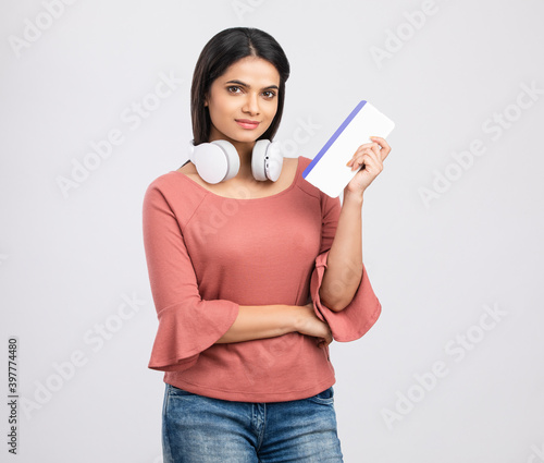 Photography Young beautiful tourist woman holding boarding pass ticket on white
