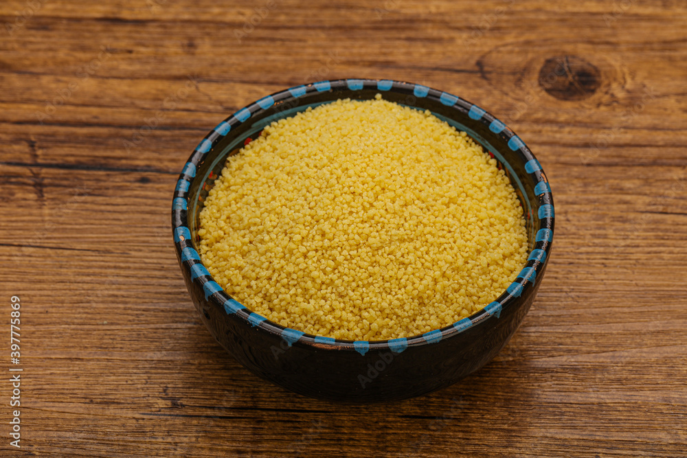 Raw cous cous heap in the bowl Raw cous cous heap in the bowl