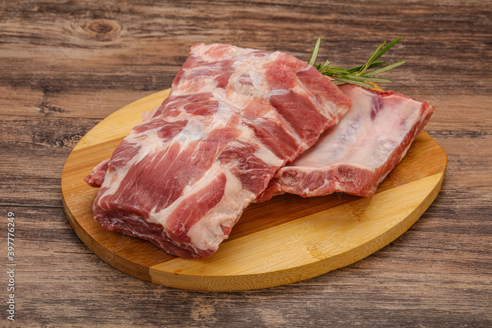 Raw pork ribs served rosemary