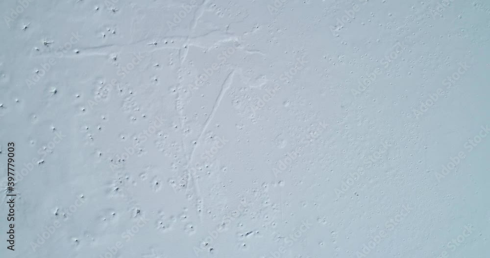 Aerial drone overhead view of frozen Alpine lake. Fusine lake in Italy. Ascending, rotating Aerial drone overhead view of frozen Alpine lake. Fusine lake in Italy. Ascending, rotating