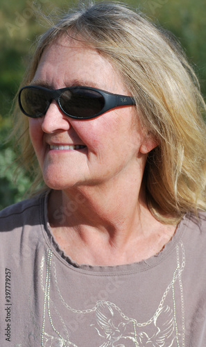 Mature female senior expressions outdoors.